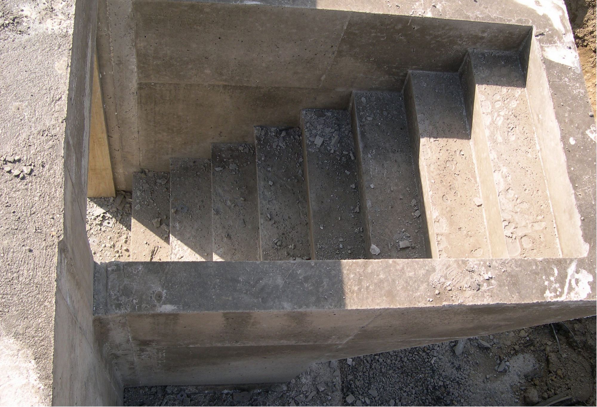 A poured concrete egress well with built-in steps